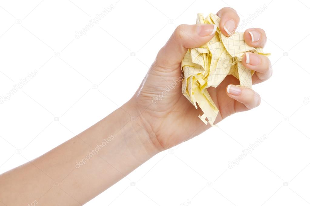 Female hand holding a crumpled paper