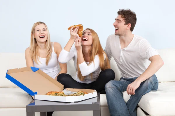 Groep jonge mensen eten pizza thuis — Stockfoto