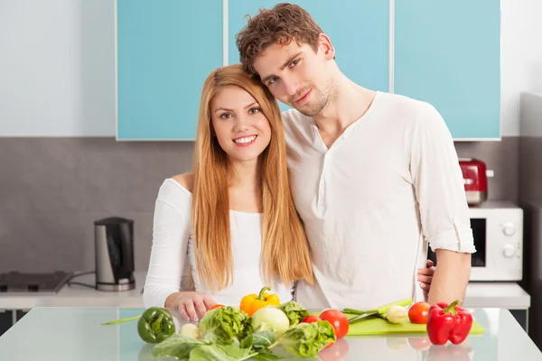 Jovem casal bonito cozinhar em casa — Fotografia de Stock