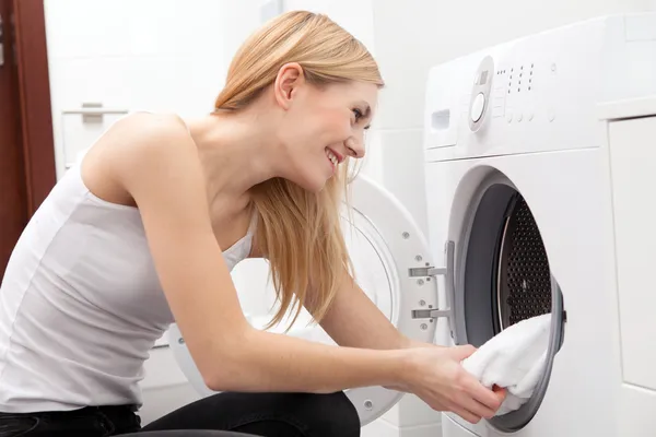 Young beautiful woman using a washing machine — Stock Photo, Image