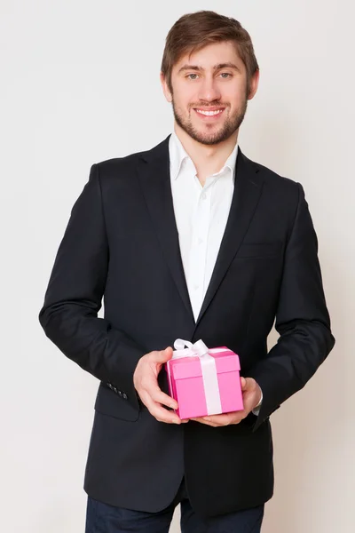 Handsome young man with a gift box — Stock Photo, Image