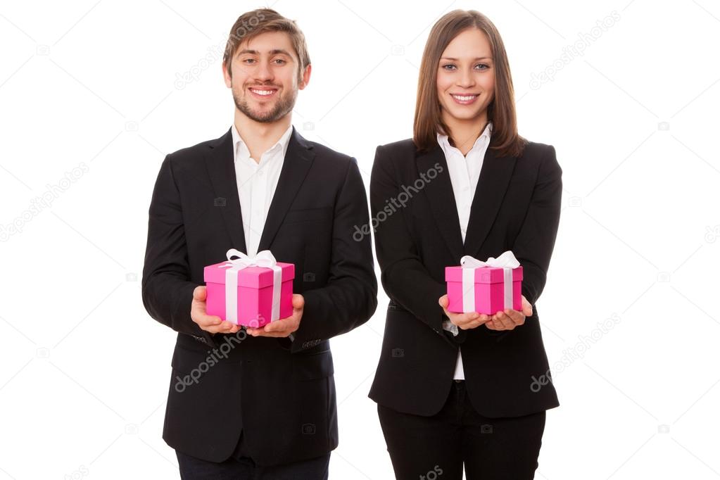 Young businessmen holding gift boxes