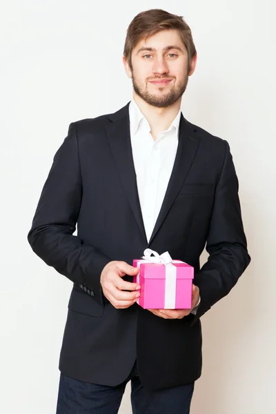 Handsome young man with a gift box — Stock Photo, Image