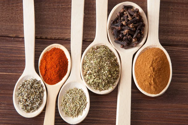 Spice assortment in wooden spoons — Stock Photo, Image