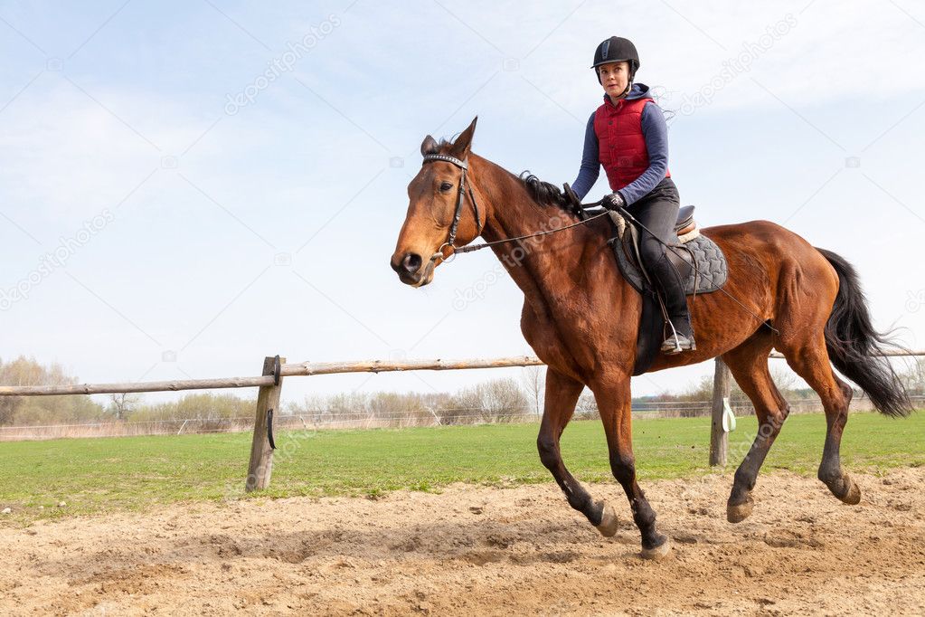 Young woman riding a horse