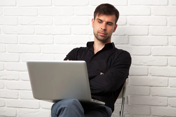 Joven hombre de negocios con un portátil — Foto de Stock