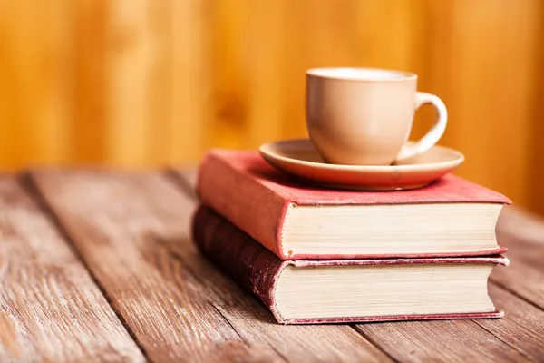 Books and a coffee cup — Stock Photo, Image