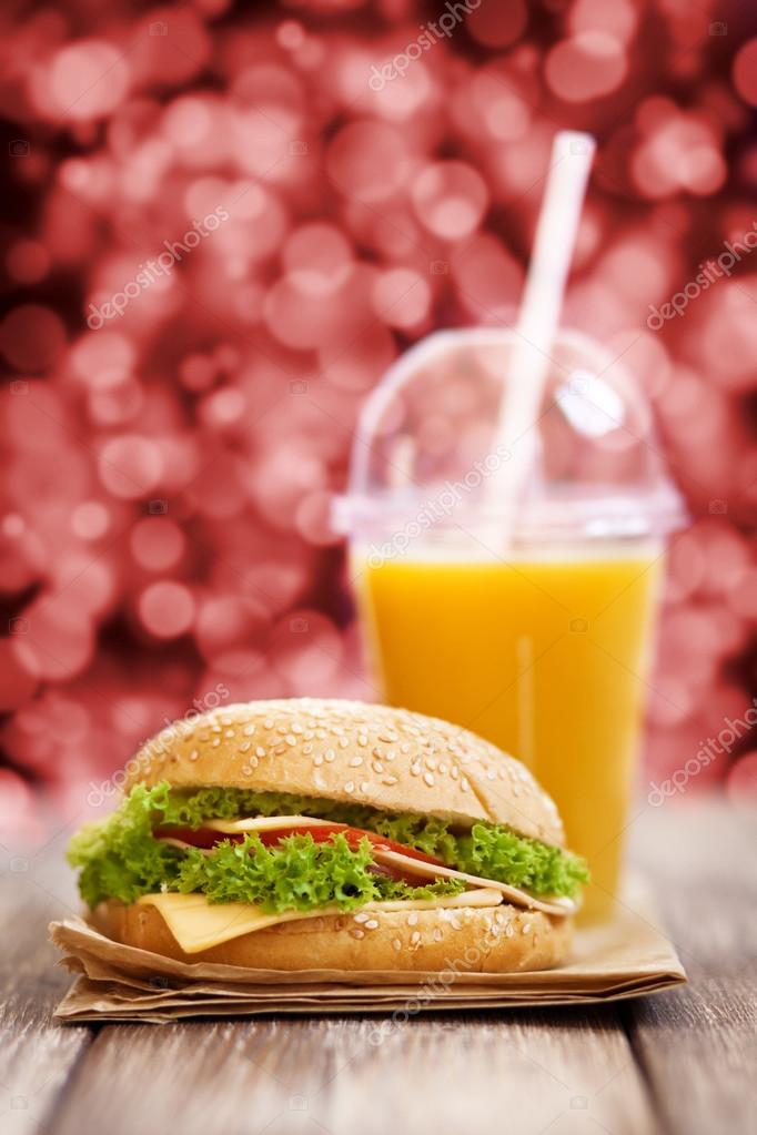 Hamburger and orange juice Stock Photo by ©gdolgikh 48134333