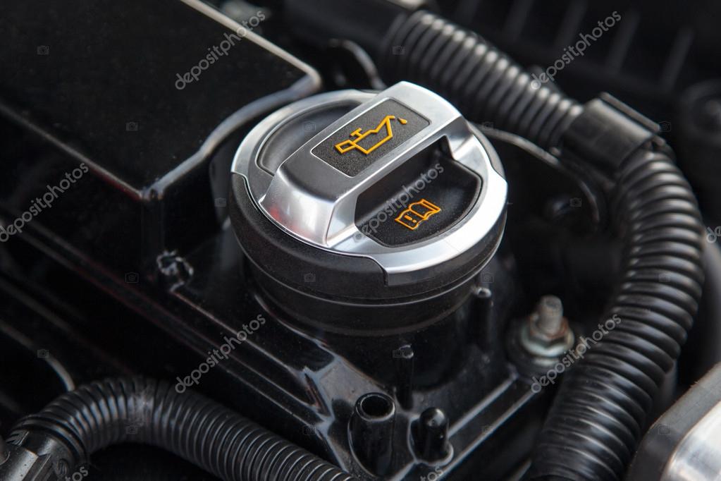 Motor oil cap under the hood of a car Stock Photo by ©gdolgikh 49050413