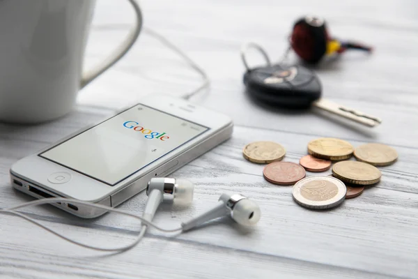 IPhone on a white wooden table — Stock Photo, Image