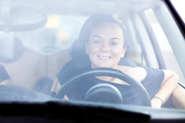 Young beautiful woman at a steering wheel — Stock Photo, Image