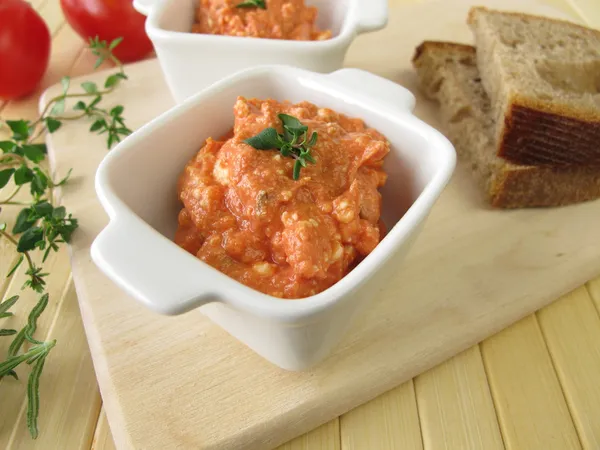 Bread spread with feta cheese, tomatoes and pizza herbs — Stock Photo, Image