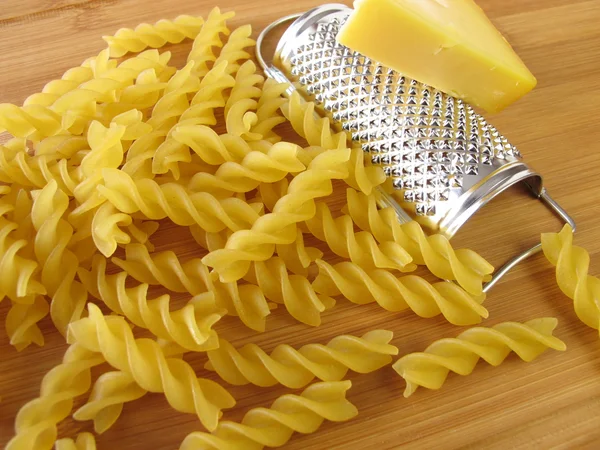 Pasta with small grater and cheese — Stock Photo, Image