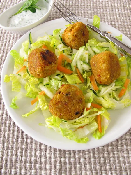 Red lentils balls on salad — Stock Photo, Image