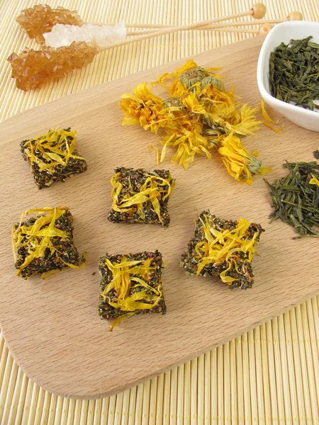 Tea bricks made of pressed green and marigold flowers — Stock Photo, Image