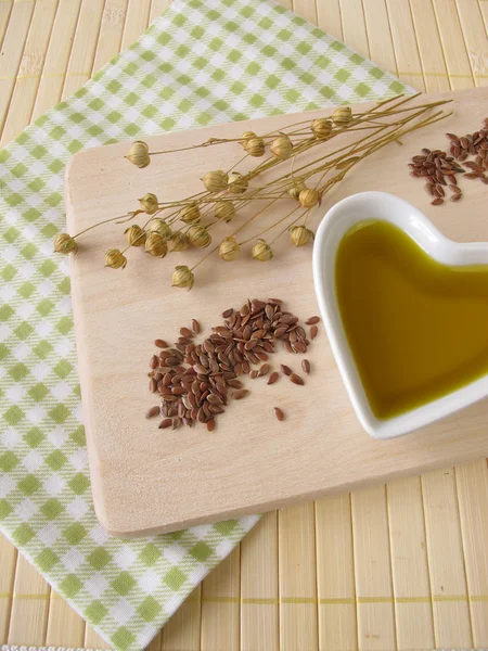Linseed oil in a small heart-shaped porcelain bowl — Stock Photo, Image