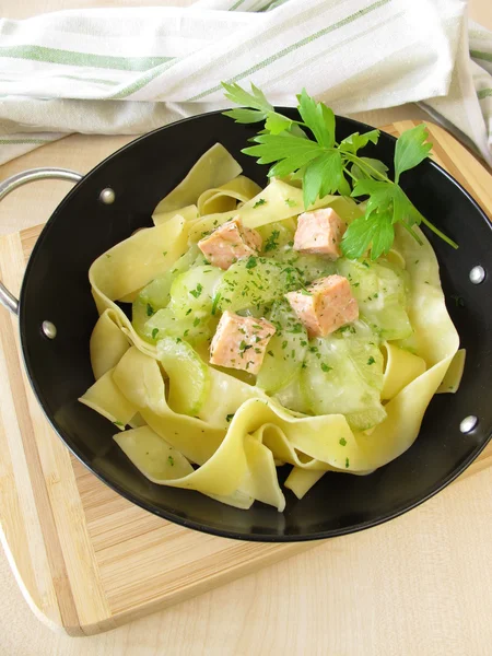 Pasta with cucumber and salmon in wok — Stock Photo, Image