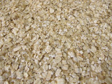 Fine rolled oats flakes on a wooden board