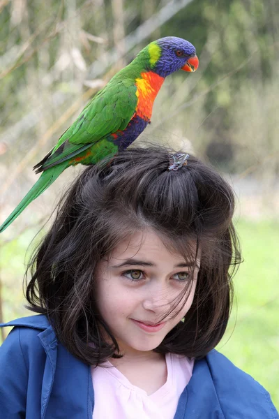 Girl and rainbow lorikeet — Stock Photo, Image
