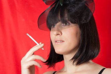 Sigaralı siyah şapkalı bir kadınla