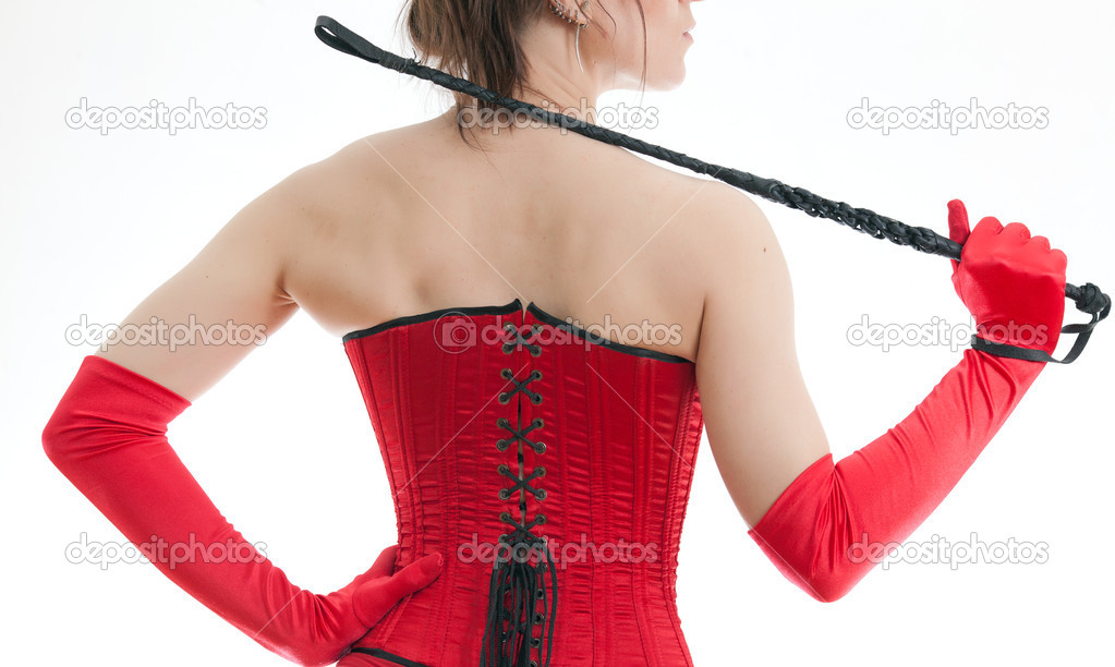 Woman in a red corset and whip