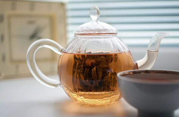 Teapot and cup on the window — Stock Photo, Image