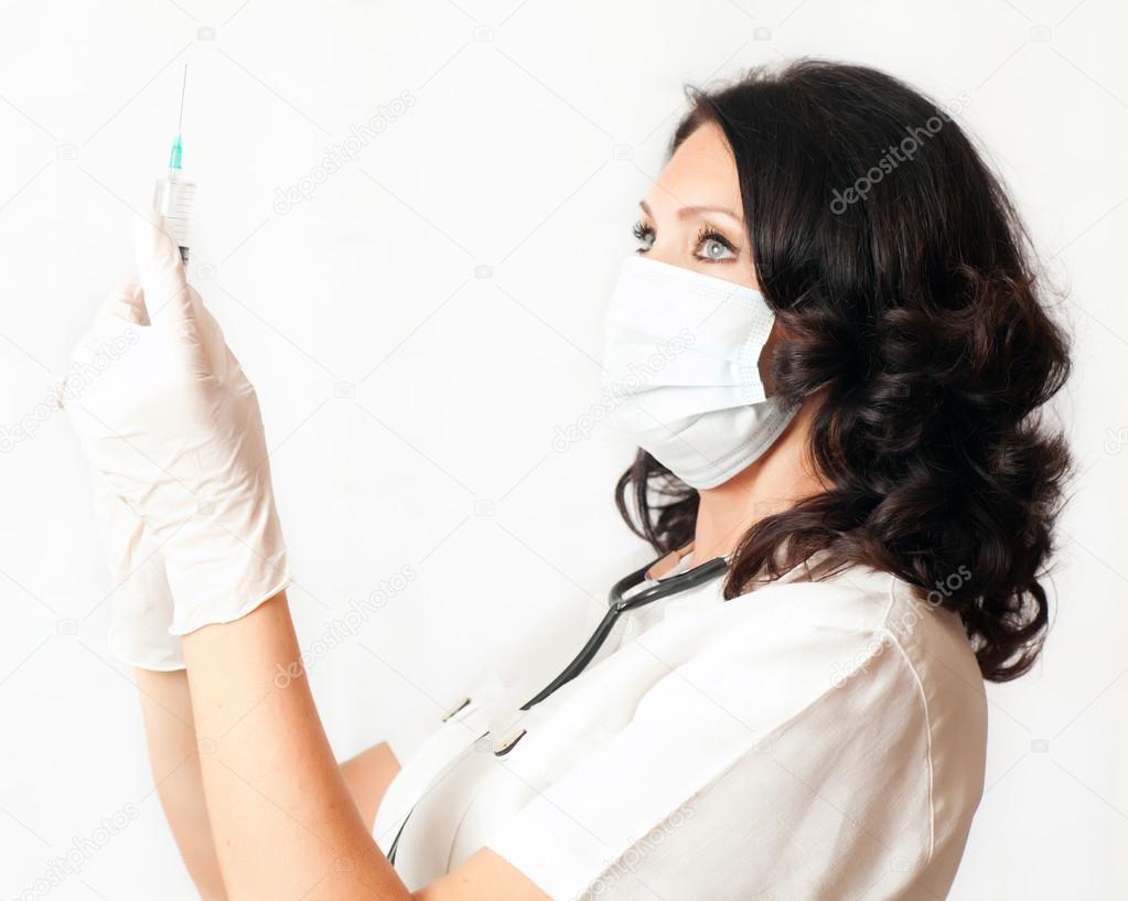 Nurse holding syringe — Stock Photo © melektaus 28352189