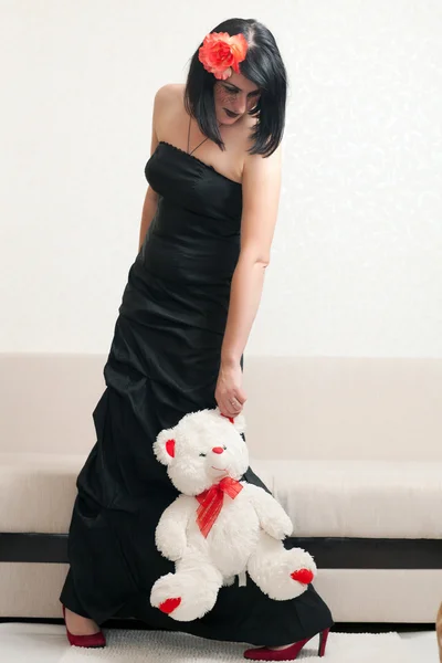 Gothic woman holding a teddy bear — Stock Photo, Image