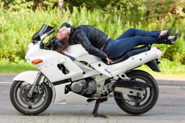 woman lies on a motorcycle clipart