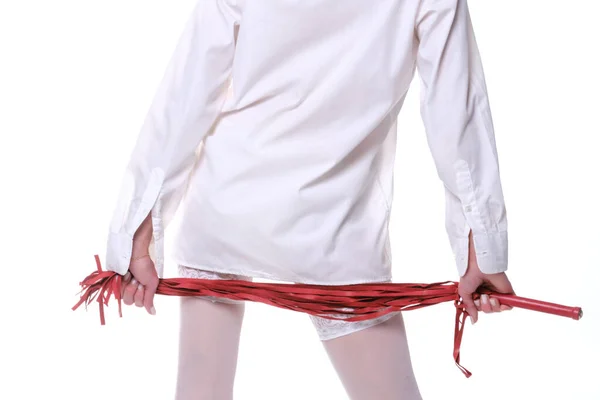 穿着白衬衫和长袜的女人在白色背景上拿着一根红鞭 — 图库照片