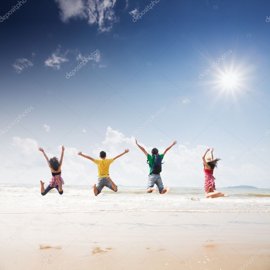 Friends jumping on beach