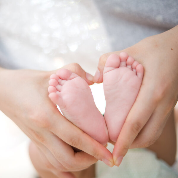 Mother's hand hold baby's foot