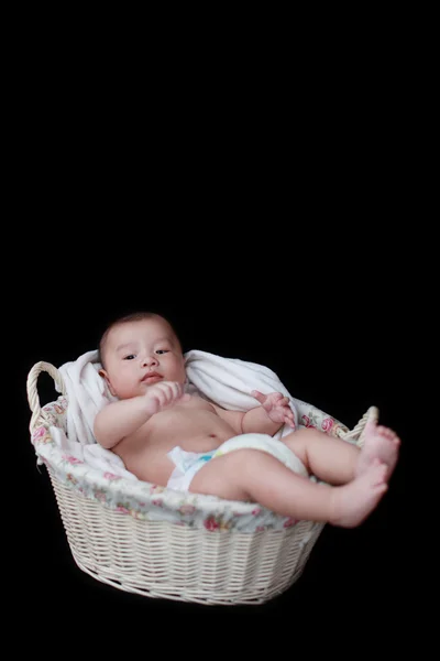 Cute baby in basket with black background — Stock Photo, Image