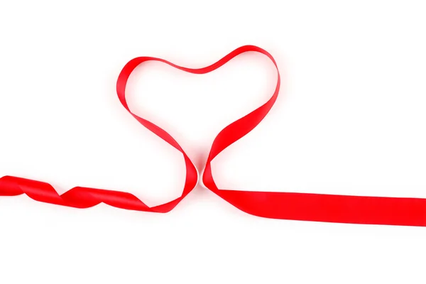 Shiny red satin ribbon with heart shape on white background with copy space. Macro with extremely shallow dof. — Stock Photo, Image