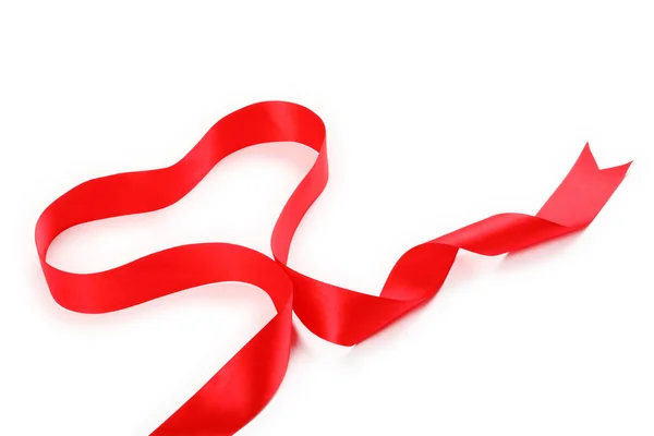 Shiny red satin ribbon with heart shape on white background with copy space. Macro with extremely shallow dof. — Stock Photo, Image