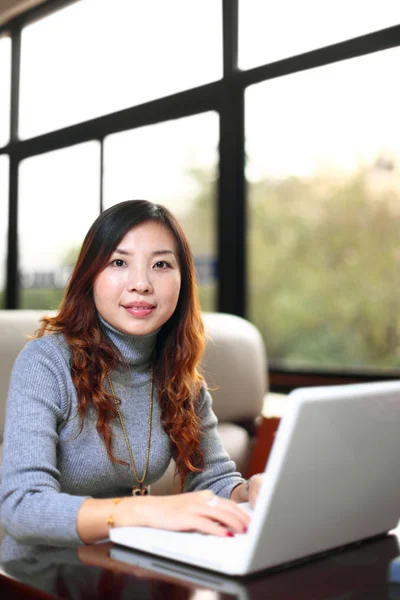 Sonriente asiático mujer de negocios con portátil — Foto de Stock