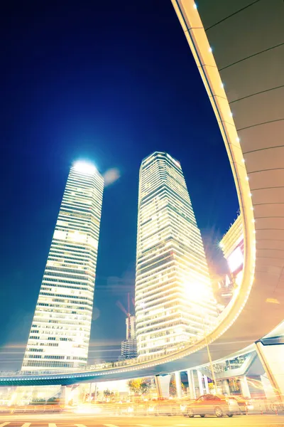 The light trails on the modern building background — Stock Photo, Image