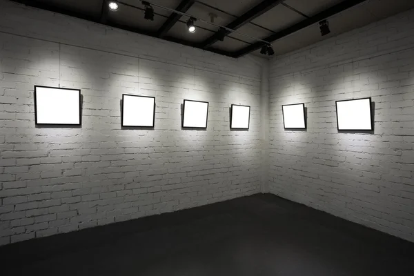 Frames on white wall in art museum — Stock Photo, Image