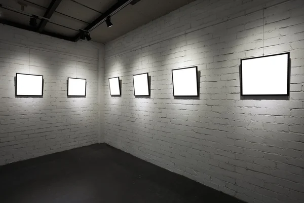 Frames on white wall in art museum — Stock Photo, Image