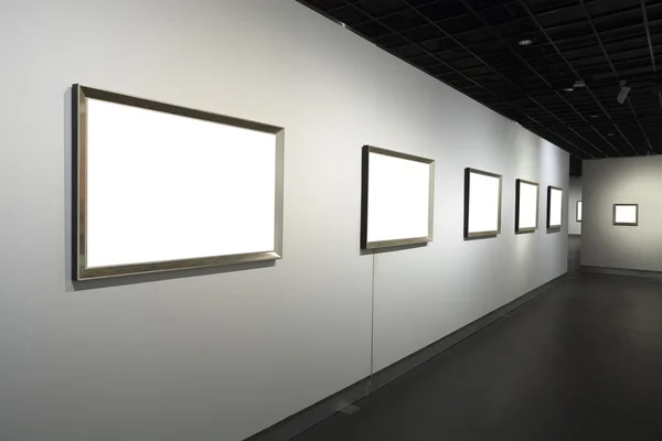 Frames on white wall in art museum — Stock Photo, Image