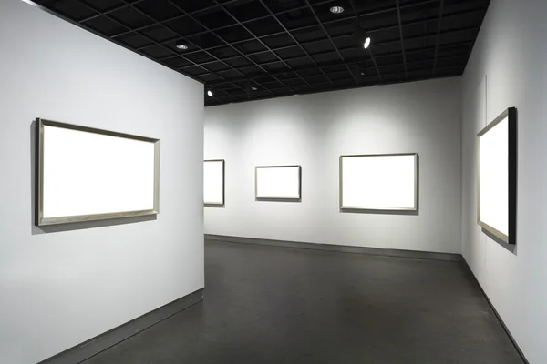 Frames on white wall in art museum — Stock Photo, Image