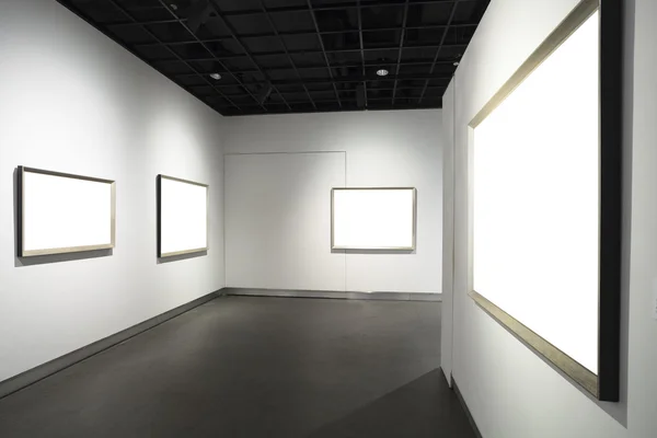 Frames on white wall in art museum — Stock Photo, Image