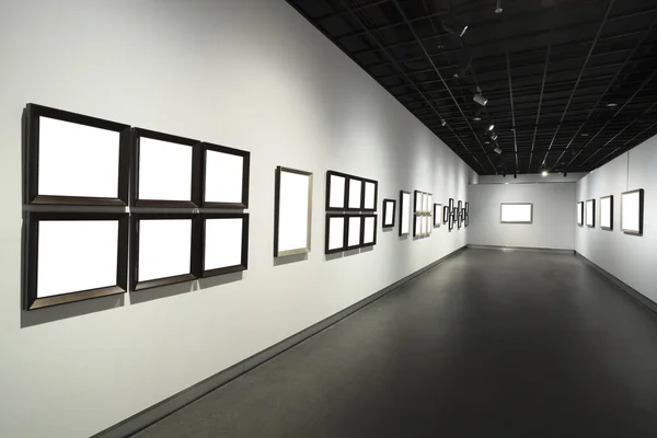 Frames on white wall in art museum — Stock Photo, Image