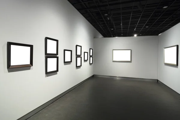 Frames on white wall in art museum — Stock Photo, Image