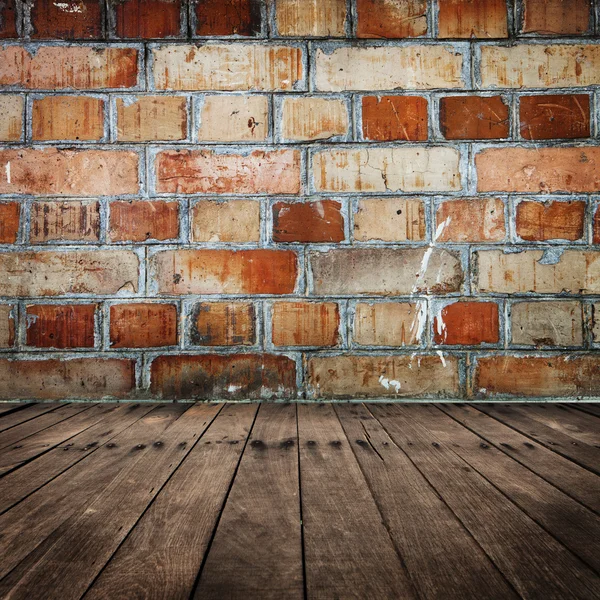 Bakstenen muur met houten vloer — Stockfoto
