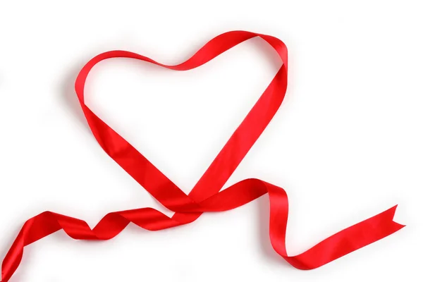 Red ribbon forming heart — Stock Photo, Image