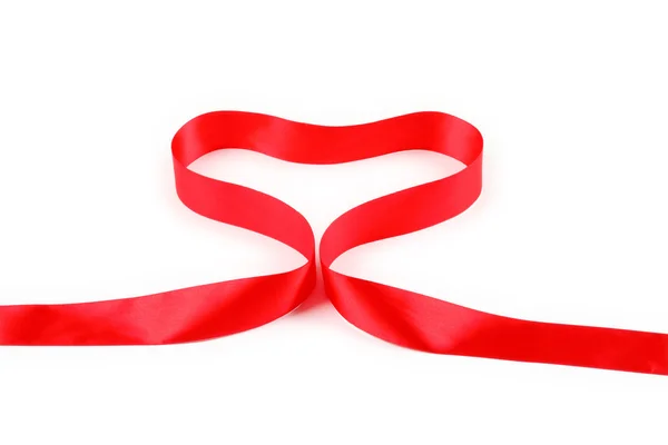 Red ribbon forming heart — Stock Photo, Image