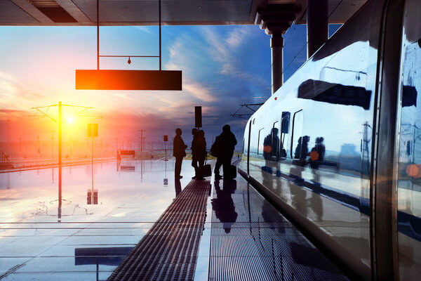 Train stop at railway station with sunset