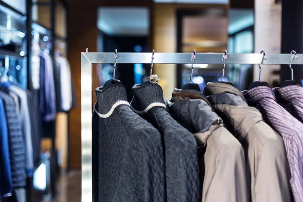 Row of men's suits hanging in closet. — Stock Photo, Image