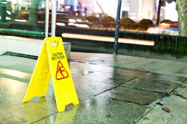 freshly mopped hallway with a caution sign in English. clipart